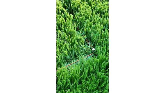Setting out football pitch reference points on laid artificial turf