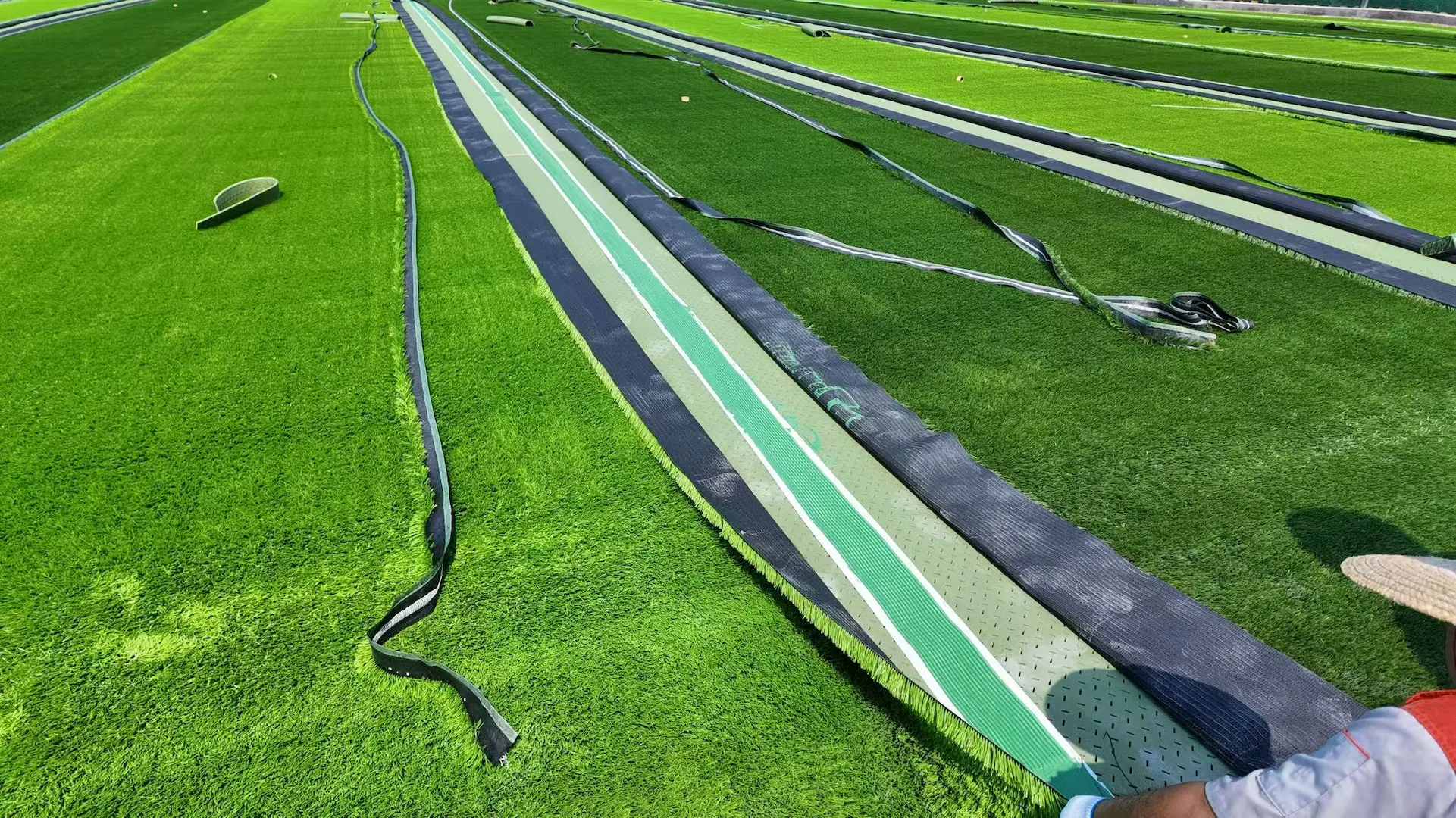 Football field white marking lines installed in artificial turf