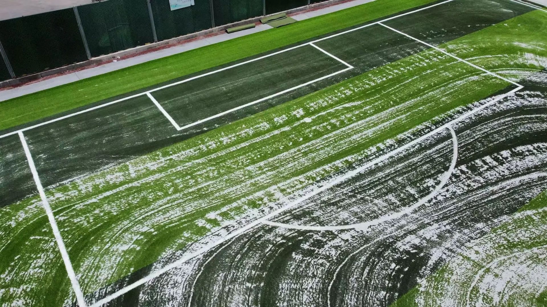 Quartz sand infill distributed on an artificial turf football pitch